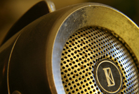 Economica Podcasts: Image of an old-school rusted microphone