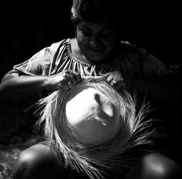 woman weaving a panama hat