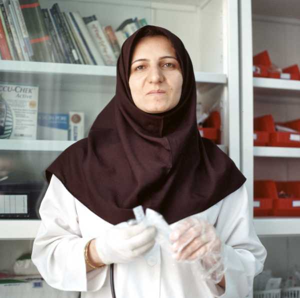 arab nurse holding a needle and wearing a hijab